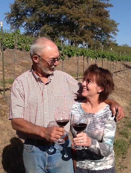 John and Phyllis Bremer enjoy a glass of wine in their vineyard.